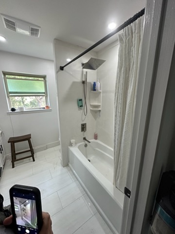 Completed bathroom remodel with new tub, shower and fixtures