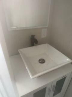 New vessel sink and faucet installed on a bathroom vanity