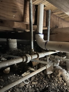 PVC drain and supply piping repaired under a pier-and-beam home